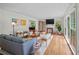 Bright living room featuring hardwood floors, large windows, fireplace, and comfortable seating arrangement at 3449 Parkview Dr, Atlanta, GA 30337