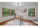 Inviting home office boasts wood floors, panelled walls, views from large windows, and bright lighting at 3449 Parkview Dr, Atlanta, GA 30337