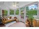 Bright sunroom with large windows showcasing the outdoor view, furnished with a cozy couch at 3449 Parkview Dr, Atlanta, GA 30337