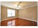 Bedroom with hardwood floors, ceiling fan, and natural light from the window at 4095 Boles Creek Dr, Duluth, GA 30096