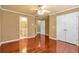 Bedroom featuring hardwood floors, ceiling fan, and access to ensuite bathroom and closet at 4095 Boles Creek Dr, Duluth, GA 30096