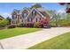 Traditional brick home with manicured lawn, mature landscaping, and a paved driveway creating an inviting curb appeal at 4095 Boles Creek Dr, Duluth, GA 30096