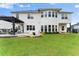 Expansive backyard with lush lawn, a pergola, and ample space for outdoor activities at 4105 Woodwind Dr, Cumming, GA 30028