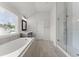 Bright bathroom with a soaking tub, glass-enclosed shower, and double sinks at 4105 Woodwind Dr, Cumming, GA 30028