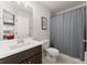 Well-lit bathroom with a shower and dark vanity at 4105 Woodwind Dr, Cumming, GA 30028