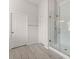Clean bathroom with a glass-enclosed shower and tile flooring at 4105 Woodwind Dr, Cumming, GA 30028