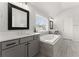 Elegant bathroom features a soaking tub, double vanities, and wood-look tile floors at 4105 Woodwind Dr, Cumming, GA 30028