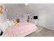Comfortable bedroom with soft lighting, a pink comforter, and neutral walls at 4105 Woodwind Dr, Cumming, GA 30028
