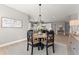 Charming dining area features a round table, modern lighting, and an open view into the kitchen at 4105 Woodwind Dr, Cumming, GA 30028