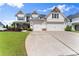 Beautiful two-story home with a three-car garage and a neatly landscaped front yard at 4105 Woodwind Dr, Cumming, GA 30028