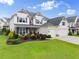 Traditional two-story home with a well-manicured lawn and a three-car garage at 4105 Woodwind Dr, Cumming, GA 30028