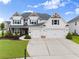 Beautiful two-story home with a three-car garage, manicured lawn, and lovely landscaping at 4105 Woodwind Dr, Cumming, GA 30028