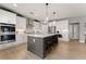 Gourmet kitchen with large center island, stainless appliances, and ample white cabinets at 4105 Woodwind Dr, Cumming, GA 30028