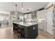 Bright kitchen features an island with bar stool seating and modern appliances at 4105 Woodwind Dr, Cumming, GA 30028