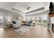 Bright living room featuring hardwood flooring, a ceiling fan and a large sectional couch and ottoman at 4105 Woodwind Dr, Cumming, GA 30028