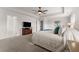 Comfortable main bedroom with a ceiling fan, neutral walls, carpet floors, and access to other rooms at 4105 Woodwind Dr, Cumming, GA 30028