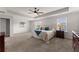 Bright main bedroom with a ceiling fan, neutral walls, carpet floors, and large windows at 4105 Woodwind Dr, Cumming, GA 30028