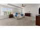 Spacious main bedroom featuring a ceiling fan, neutral walls, carpet floors, and large windows at 4105 Woodwind Dr, Cumming, GA 30028