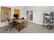 Office area featuring neutral carpet, a modern desk, shelves, and colorful wall art at 4105 Woodwind Dr, Cumming, GA 30028