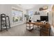 Bright home office featuring natural light from large windows, a modern desk, and neutral color palette at 4105 Woodwind Dr, Cumming, GA 30028