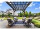 Outdoor patio area with a pergola over the sitting area at 4105 Woodwind Dr, Cumming, GA 30028