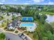 Aerial shot of the community clubhouse featuring a pool, tennis courts, lounge chairs and manicured landscaping at 4105 Woodwind Dr, Cumming, GA 30028