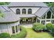 Expansive aerial view of a stately home with beautifully landscaped grounds and lush greenery at 115 Cross Roads Ct, Atlanta, GA 30327