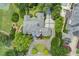 Expansive property boasts lush landscaping, circular driveway, and pristine rooflines in an exclusive neighborhood at 115 Cross Roads Ct, Atlanta, GA 30327