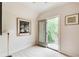 Bright room with a door to a balcony and natural light, complemented by unique artwork and neutral tones at 115 Cross Roads Ct, Atlanta, GA 30327