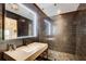 Modern bathroom featuring a sleek vanity, illuminated mirror, and contemporary tiled shower at 115 Cross Roads Ct, Atlanta, GA 30327