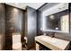 Stylish bathroom featuring a modern vanity, backlit mirror, and convenient toilet and storage at 115 Cross Roads Ct, Atlanta, GA 30327