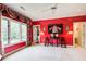Bright bedroom with bold red walls, unique decorative details, and a ceiling fan at 115 Cross Roads Ct, Atlanta, GA 30327
