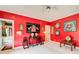 Eclectic bedroom with bright red walls, unique decor, and a ceiling fan at 115 Cross Roads Ct, Atlanta, GA 30327