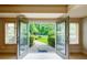 Elegant entryway with double doors opening to a beautifully landscaped backyard and pool at 115 Cross Roads Ct, Atlanta, GA 30327