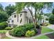 Stately two-story home with turret, surrounded by lush landscaping and mature trees at 115 Cross Roads Ct, Atlanta, GA 30327