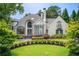 Stunning two-story home with manicured lawn, lush landscaping and stately architecture at 115 Cross Roads Ct, Atlanta, GA 30327