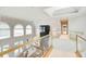 Bright foyer boasts a living room view with soaring ceilings, large windows, a marble accent wall, and elegant railings at 115 Cross Roads Ct, Atlanta, GA 30327