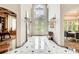 Spacious foyer with marble floors, ornate lighting, and adjacent dining area at 115 Cross Roads Ct, Atlanta, GA 30327
