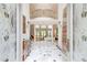 Grand foyer with marble floors, soaring ceilings, and elegant stairway at 115 Cross Roads Ct, Atlanta, GA 30327