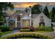 Stunning home featuring manicured landscaping, beautiful architectural details, and inviting entrance at 115 Cross Roads Ct, Atlanta, GA 30327