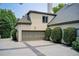 Attached garage with ample parking space, nestled within lush landscaping at 115 Cross Roads Ct, Atlanta, GA 30327