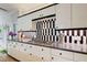 Stylish kitchen with black and white tiling backsplash, gas stovetop and white cabinetry at 115 Cross Roads Ct, Atlanta, GA 30327