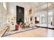 Spacious living room with a fireplace, and glass doors to view the exterior at 115 Cross Roads Ct, Atlanta, GA 30327