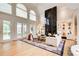Open living room with large windows and a marble fireplace at 115 Cross Roads Ct, Atlanta, GA 30327