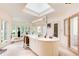 Bright main bathroom featuring a skylight, marble floors, and glass shower at 115 Cross Roads Ct, Atlanta, GA 30327