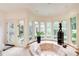 Modern main bathroom featuring a sunken tub, marble floors, and elegant decor at 115 Cross Roads Ct, Atlanta, GA 30327