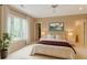 Bright main bedroom with a ceiling fan, neutral walls and carpet, and a large window to let the sun shine in at 115 Cross Roads Ct, Atlanta, GA 30327