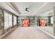 Spacious room with two windows, a fan, a mirror, and artistic décor with wall paneling at 115 Cross Roads Ct, Atlanta, GA 30327