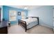 Comfortable blue bedroom with large windows, carpet, ceiling fan, and ample natural light at 199 Eastham Ct, Suwanee, GA 30024