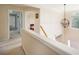 Hallway with view to bedroom, chandelier, and access to various rooms at 199 Eastham Ct, Suwanee, GA 30024